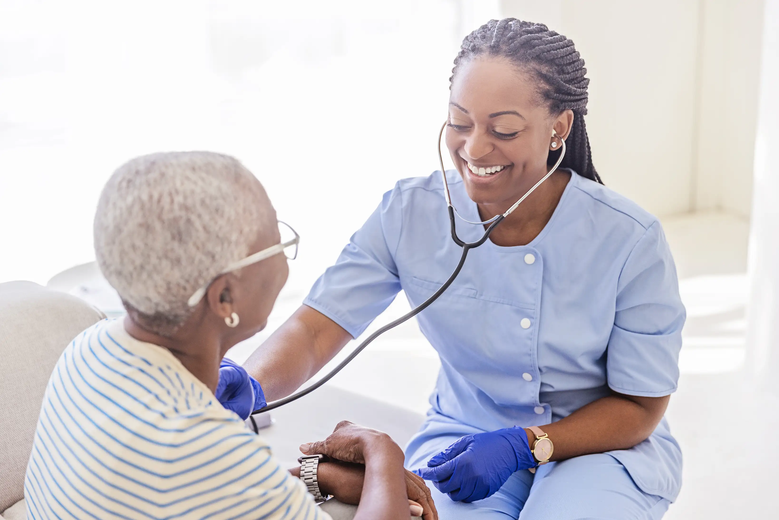Caregiver with elderly client at home
